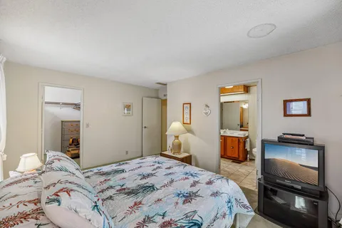 a bedroom with a bed and a television