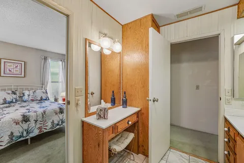 a en suite bathroom with a double vanity sink and a mirror