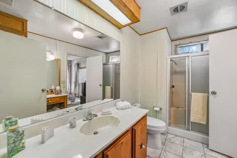 a bathroom with a sink toilet and shower