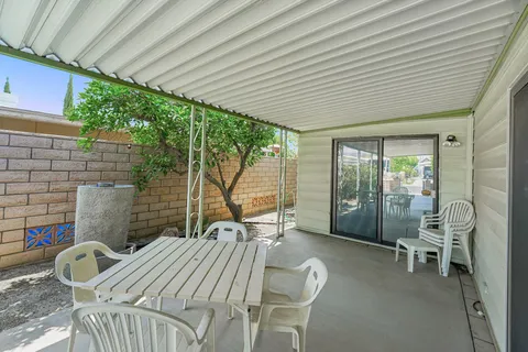 a balcony with furniture and a garden