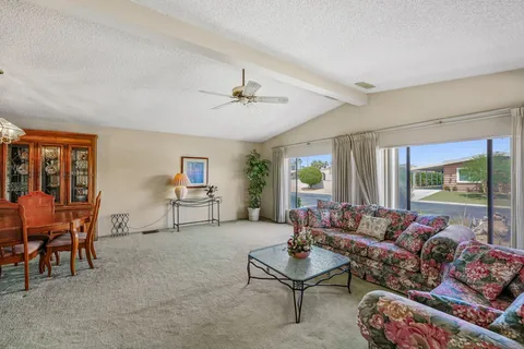 a living room with furniture and a chandelier