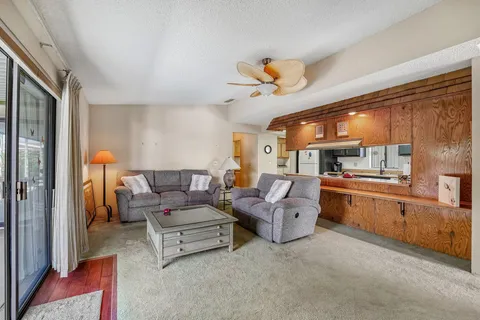 a living room with furniture and a kitchen