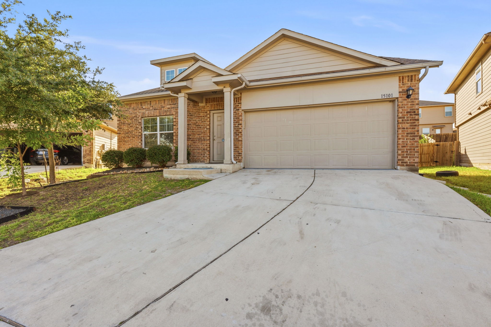 15101 Shell Bark Cove Austin, TX 78724 - Photo 1 of 26 Brick facade residence featuring a two-car garage, covered porch entry with columns, and a concrete driveway