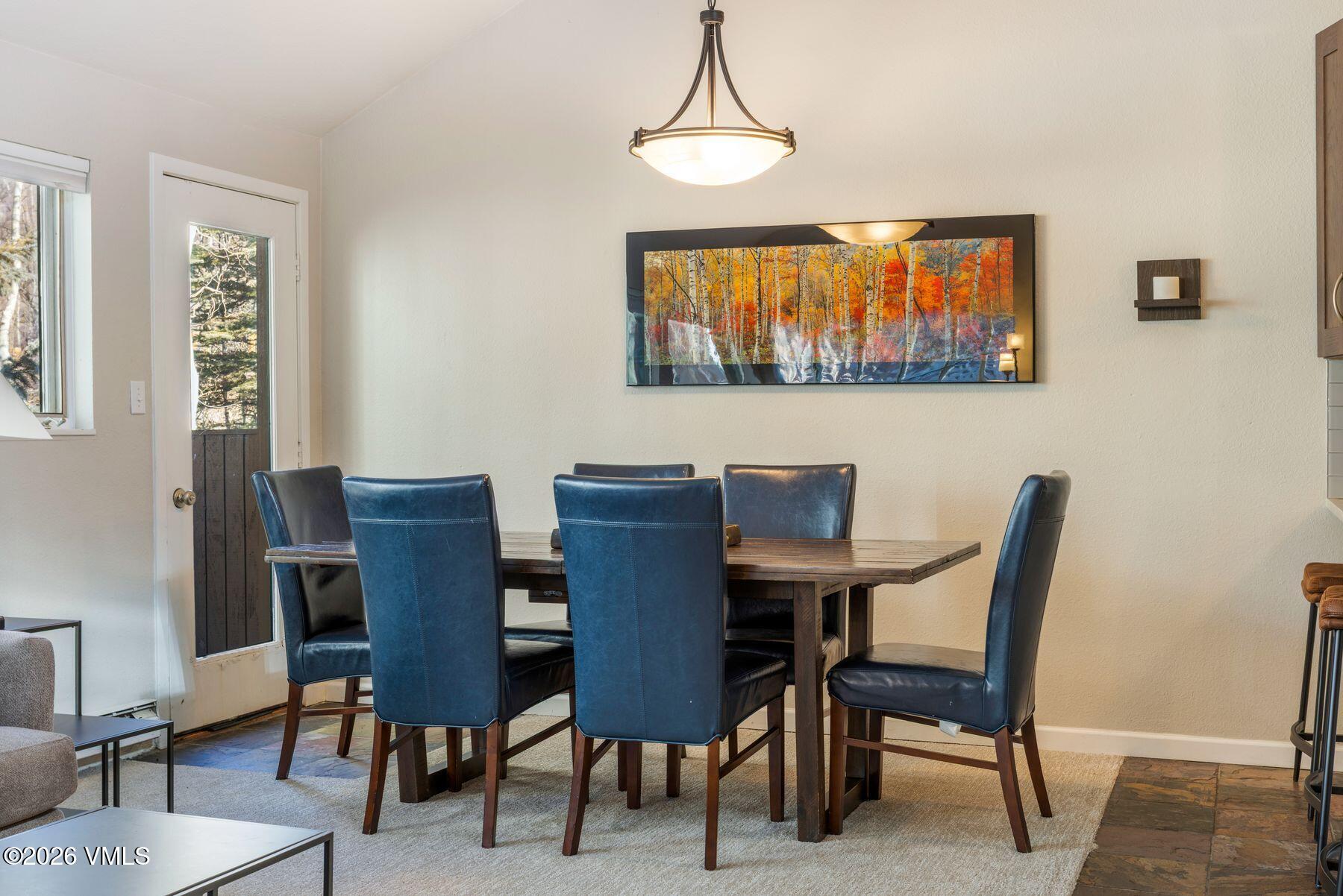 3911 Big Horn Road, Unit 1D Vail, CO 81657 - Photo 12 of 31 a view of a dining room with furniture window and wooden floor