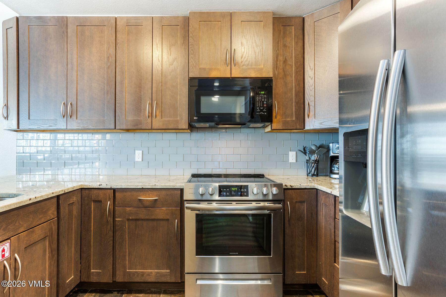3911 Big Horn Road, Unit 1D Vail, CO 81657 - Photo 16 of 31 a kitchen with a sink and a refrigerator