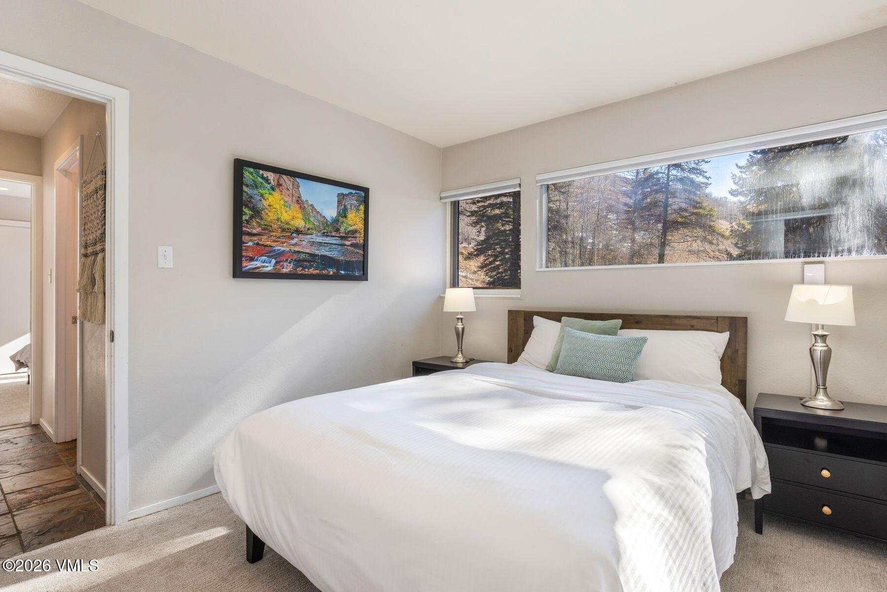 3911 Big Horn Road, Unit 1D Vail, CO 81657 - Photo 17 of 31 a bedroom with a bed and a painting on the wall
