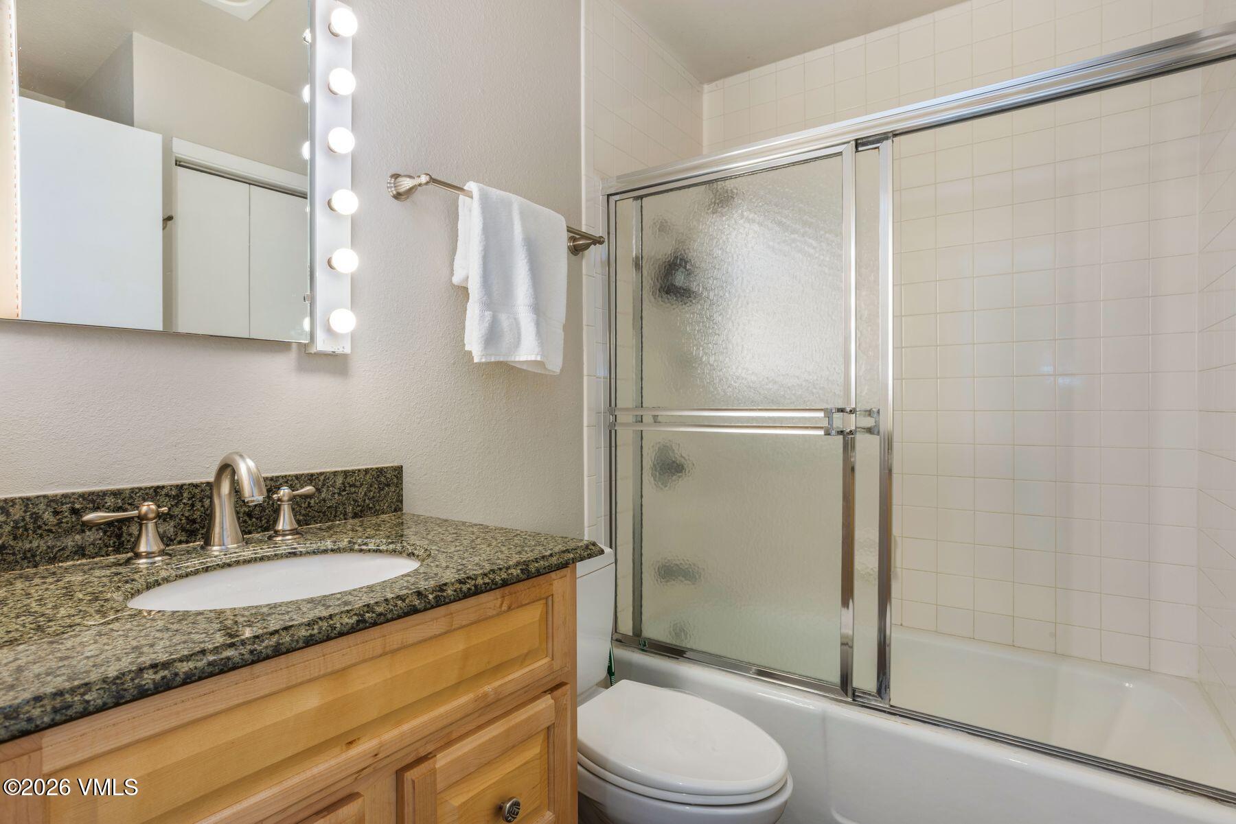 3911 Big Horn Road, Unit 1D Vail, CO 81657 - Photo 18 of 31 a bathroom with a granite countertop sink toilet and shower