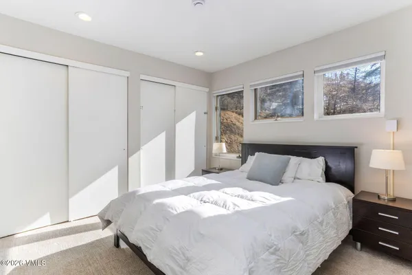 a bathroom with a granite countertop sink and a washing machine