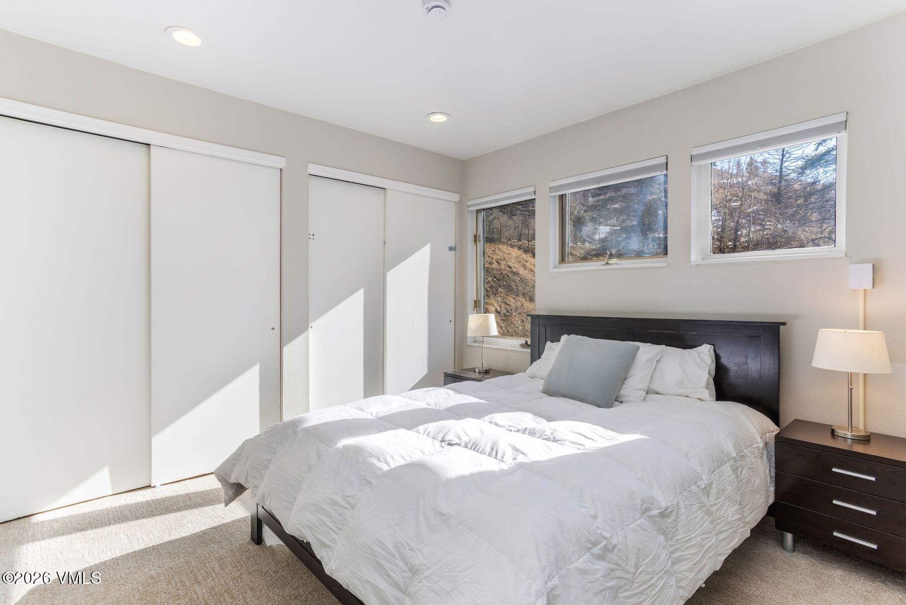 3911 Big Horn Road, Unit 1D Vail, CO 81657 - Photo 19 of 31 a bedroom with a large bed and a window