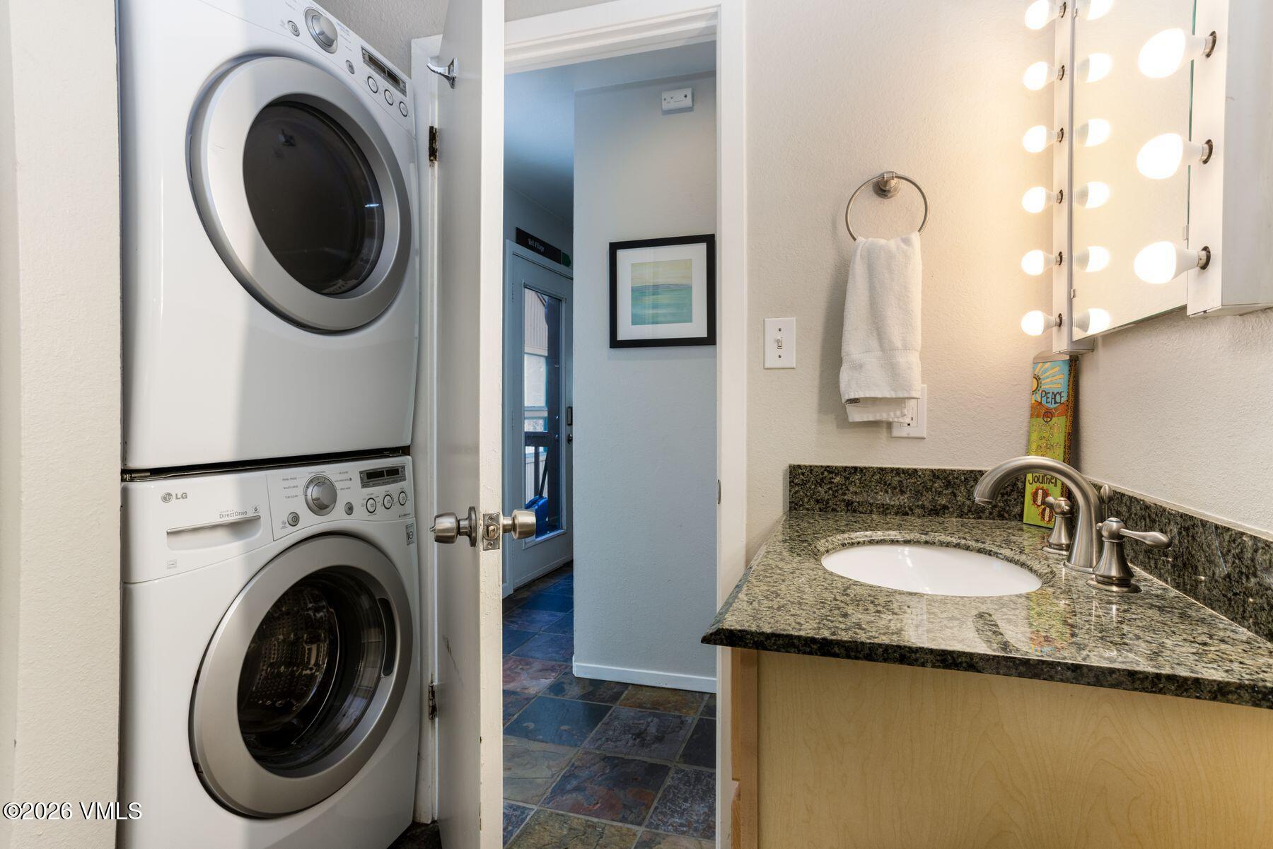 3911 Big Horn Road, Unit 1D Vail, CO 81657 - Photo 20 of 31 a bathroom with a granite countertop sink and a washing machine