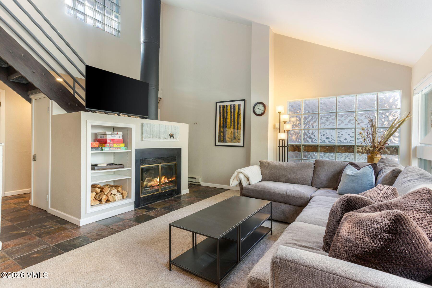 3911 Big Horn Road, Unit 1D Vail, CO 81657 - Photo 2 of 31 a living room with furniture a flat screen tv and a fireplace