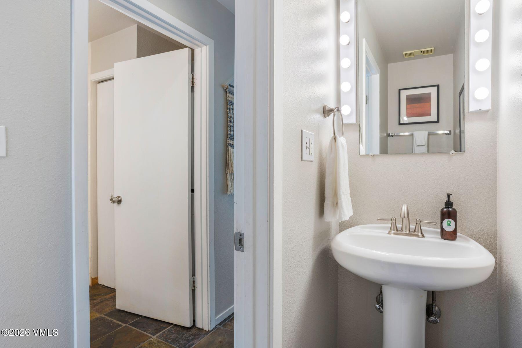 3911 Big Horn Road, Unit 1D Vail, CO 81657 - Photo 21 of 31 a bathroom with a sink and a mirror