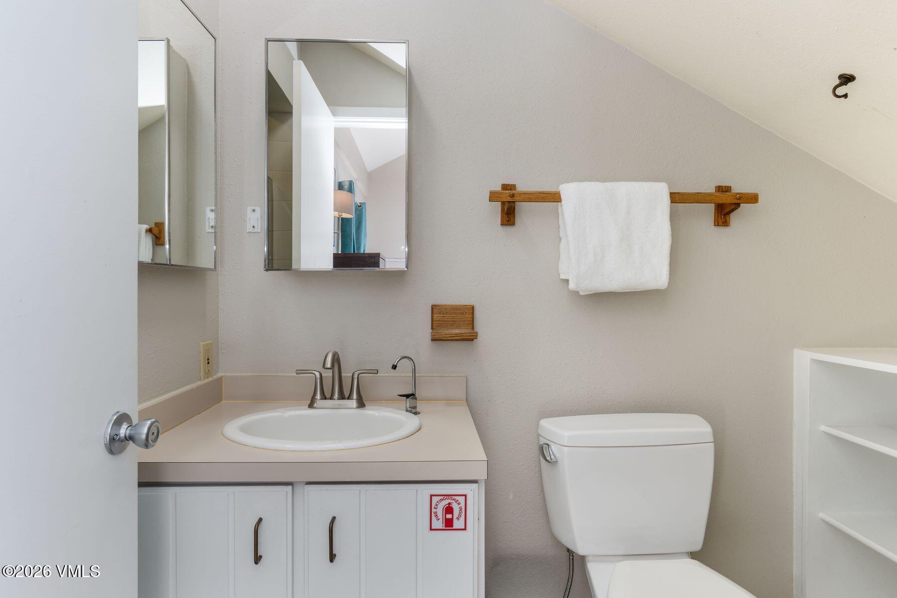 3911 Big Horn Road, Unit 1D Vail, CO 81657 - Photo 25 of 31 a bathroom with a toilet sink and mirror