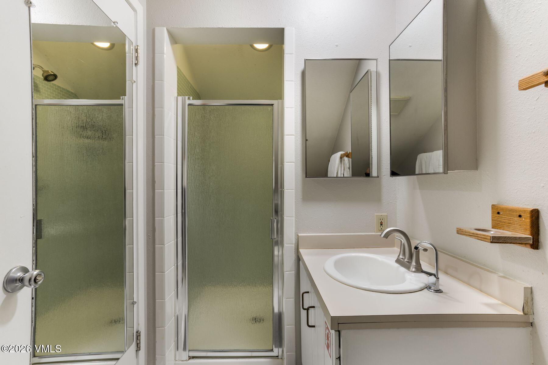 3911 Big Horn Road, Unit 1D Vail, CO 81657 - Photo 26 of 31 a bathroom with a sink and mirror