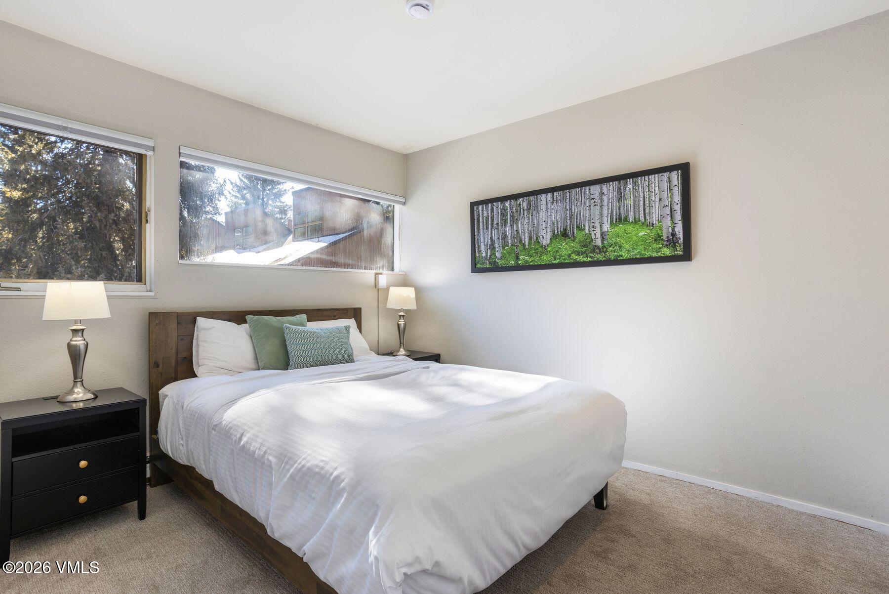 3911 Big Horn Road, Unit 1D Vail, CO 81657 - Photo 4 of 31 a bedroom with a bed and painting on the wall