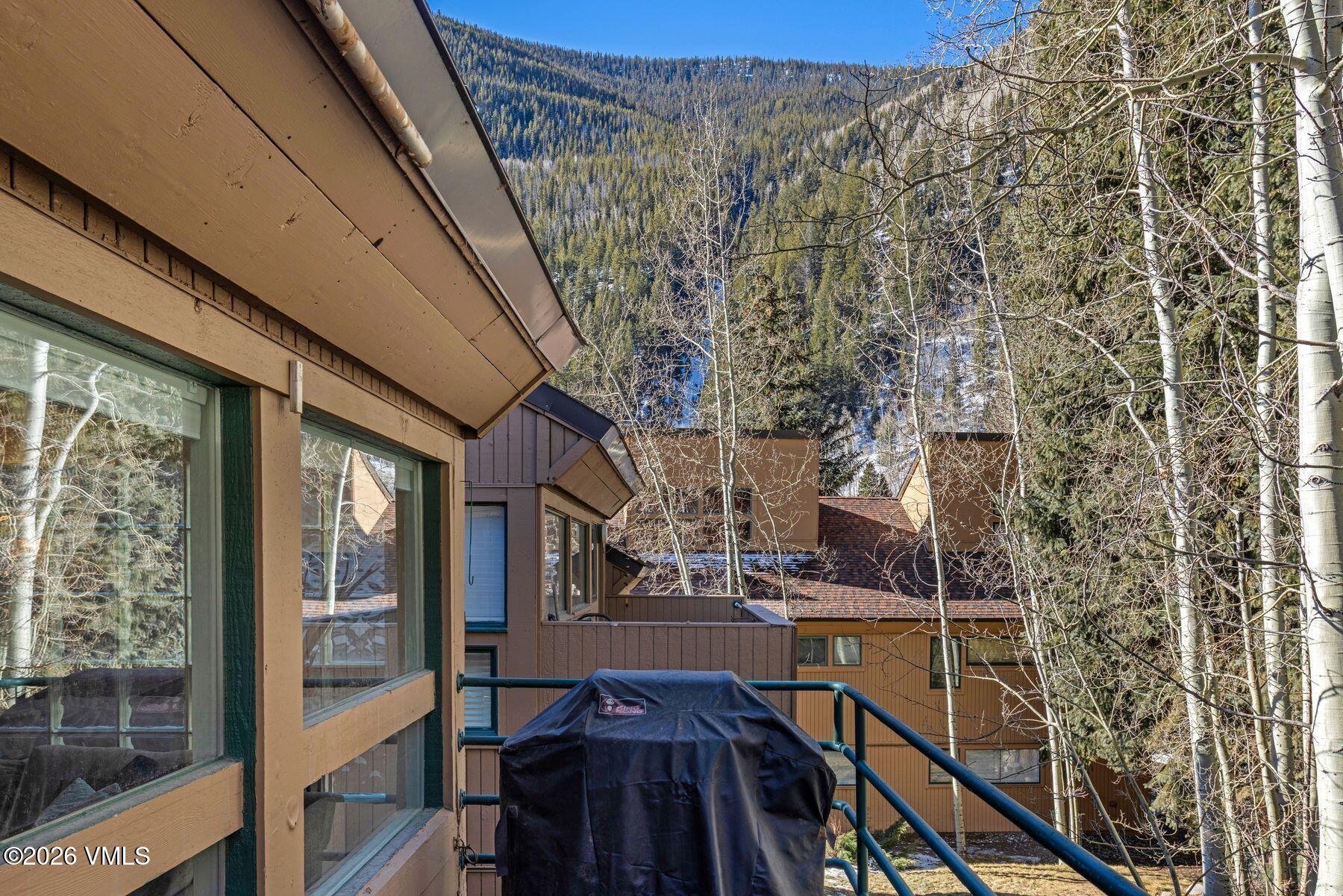 3911 Big Horn Road, Unit 1D Vail, CO 81657 - Photo 7 of 31 a view of balcony with wooden floor and fence