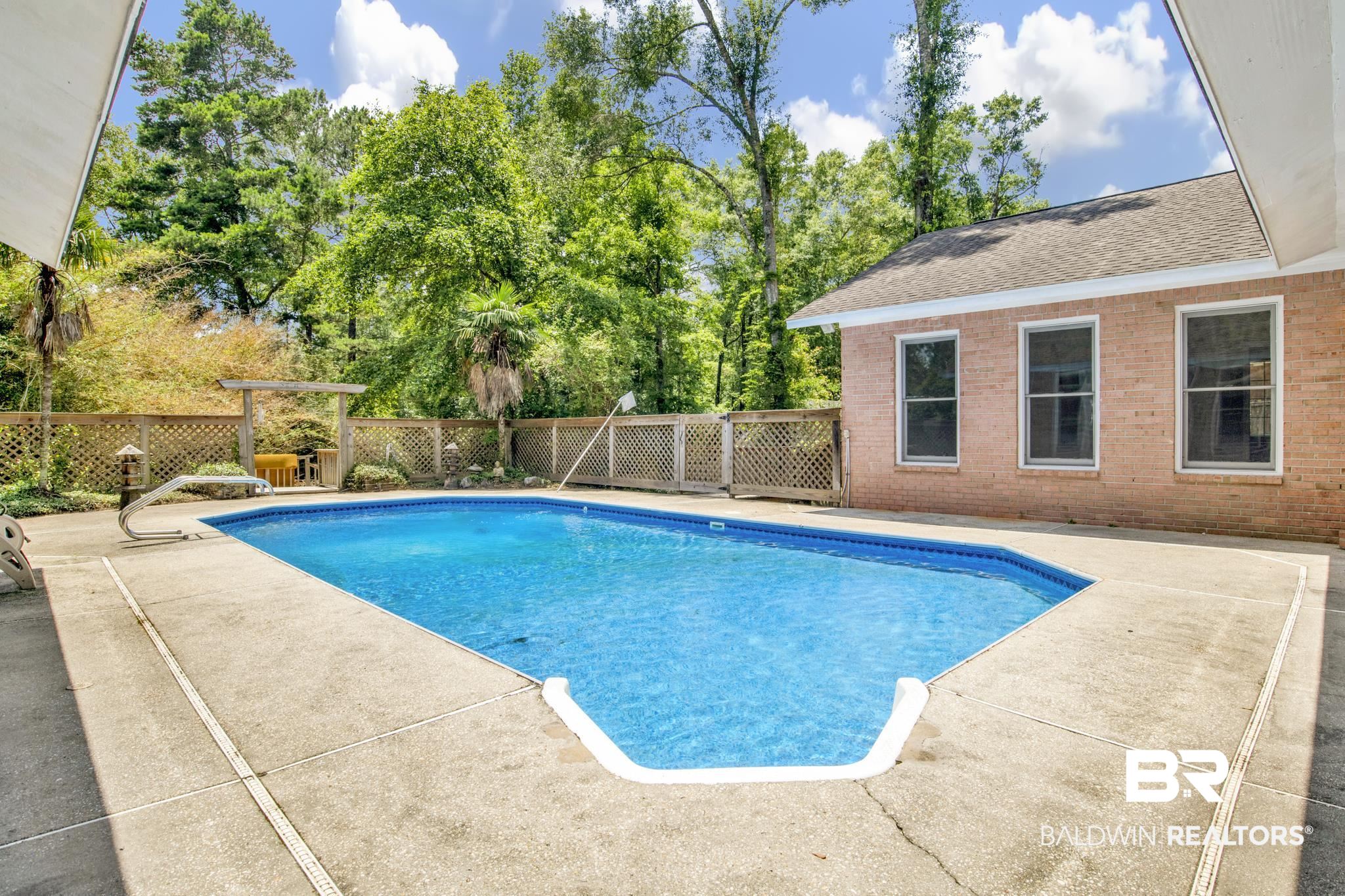 6805 Hunters Court Mobile, AL 36695 - Photo 36 of 37 View of swimming pool featuring a patio area and view of scattered trees