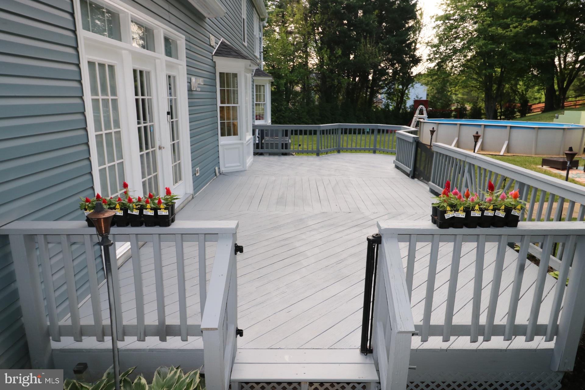 11901 Rustic Farm Court Germantown, MD 20874 - Photo 109 of 134 Charming deck with vibrant blooms.