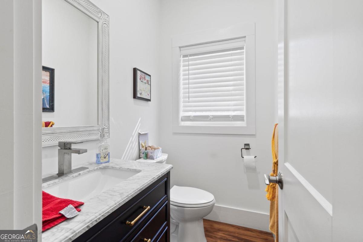 392 Big Oconee River Road Sparta, GA 31087 - Photo 13 of 69 a bathroom with a sink toilet and a mirror