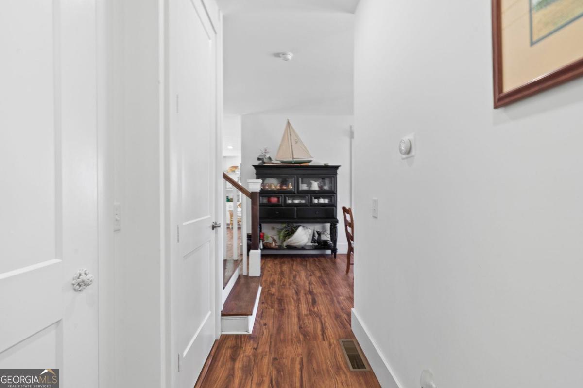 392 Big Oconee River Road Sparta, GA 31087 - Photo 14 of 69 a view of a hallway with wooden floor and a hallway