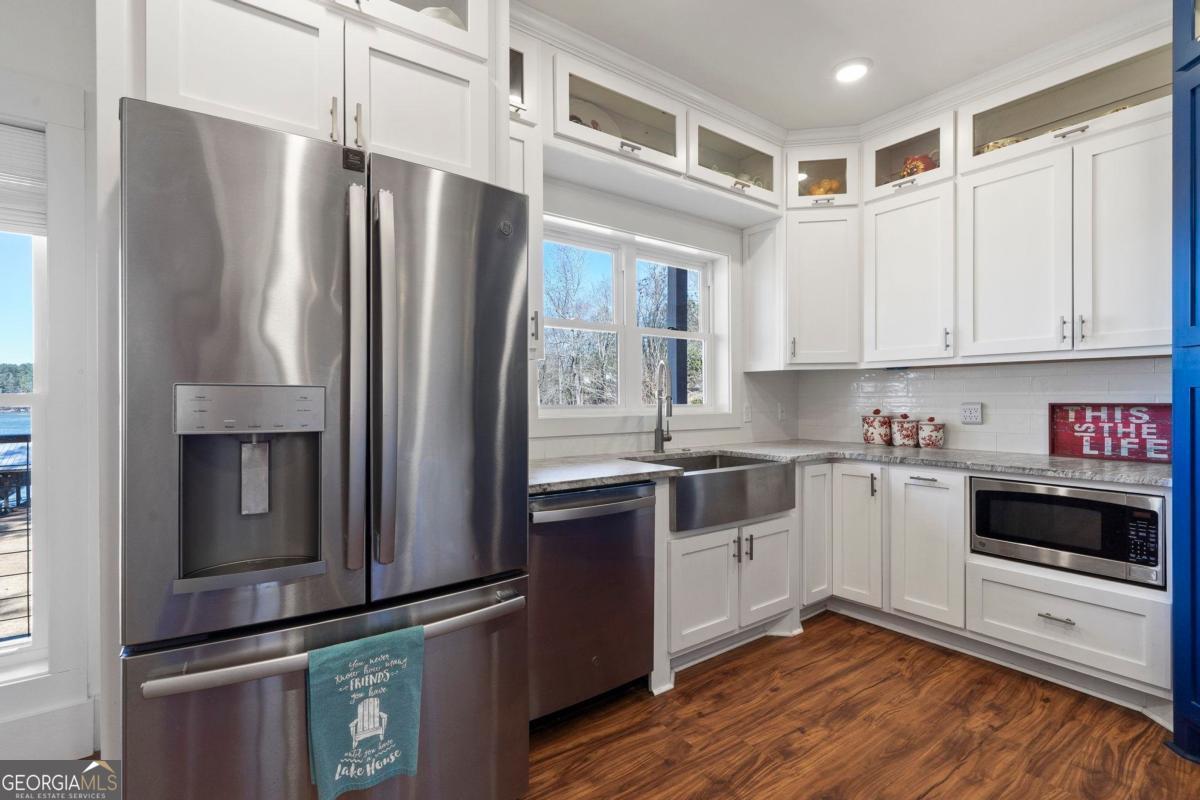392 Big Oconee River Road Sparta, GA 31087 - Photo 18 of 69 a kitchen with stainless steel appliances a refrigerator sink and microwave