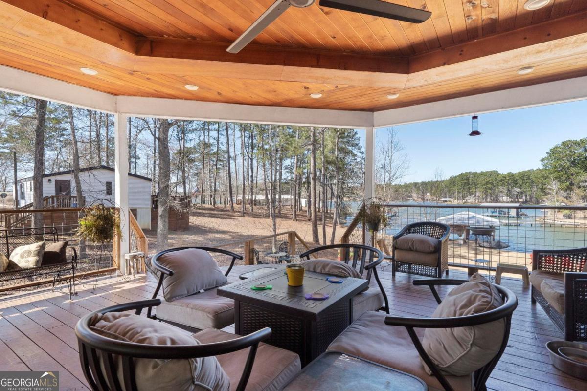 392 Big Oconee River Road Sparta, GA 31087 - Photo 28 of 69 a living room with furniture and a floor to ceiling window