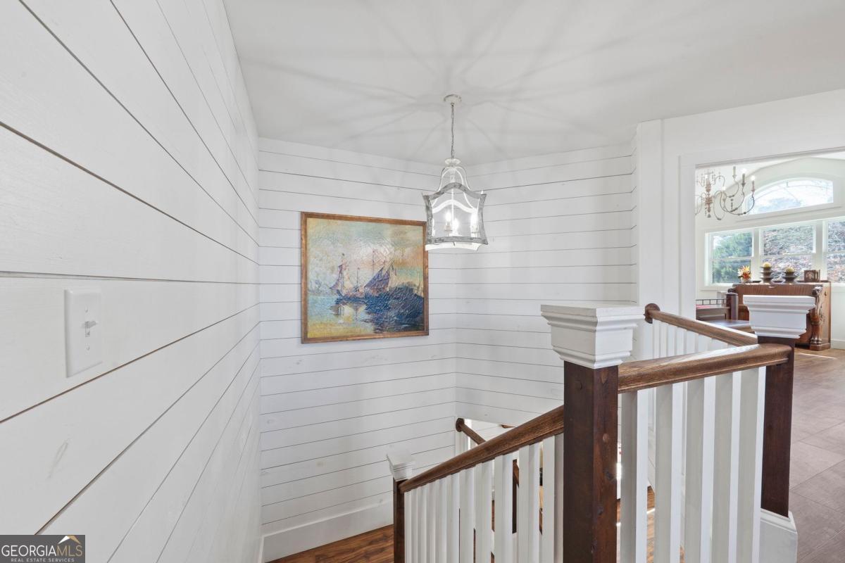 392 Big Oconee River Road Sparta, GA 31087 - Photo 33 of 69 a view of a hallway with wooden floor and staircase