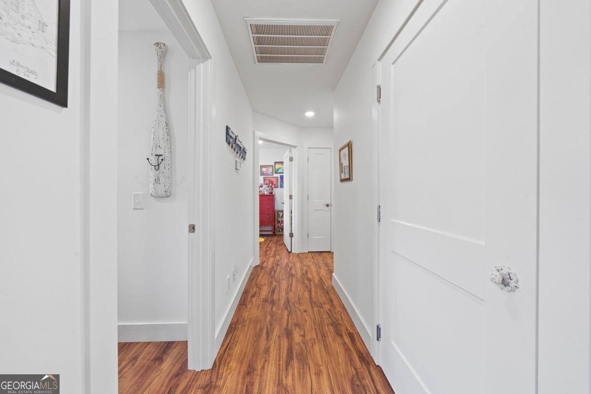 392 Big Oconee River Road Sparta, GA 31087 - Photo 45 of 69 a view of a hallway with wooden floor and closet