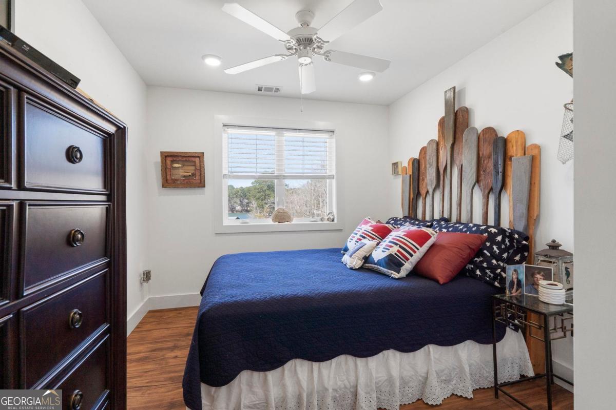 392 Big Oconee River Road Sparta, GA 31087 - Photo 51 of 69 a bedroom with a bed and a chandelier