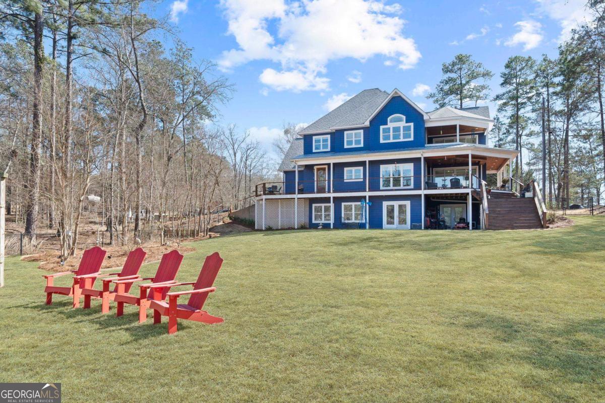 392 Big Oconee River Road Sparta, GA 31087 - Photo 60 of 69 a front view of a house with swimming pool and sitting area