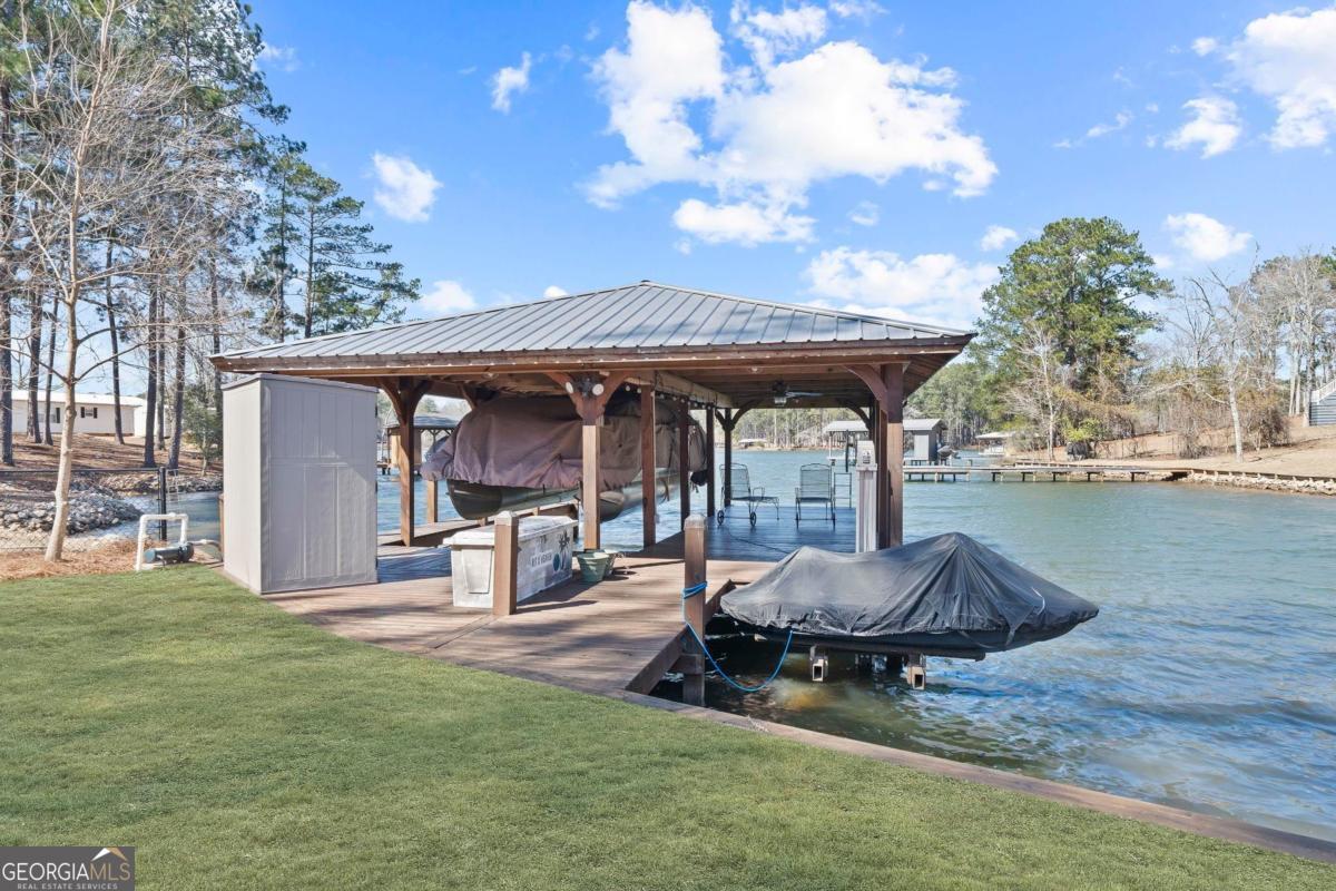392 Big Oconee River Road Sparta, GA 31087 - Photo 62 of 69 a view of a backyard with table and chairs and a fire pit