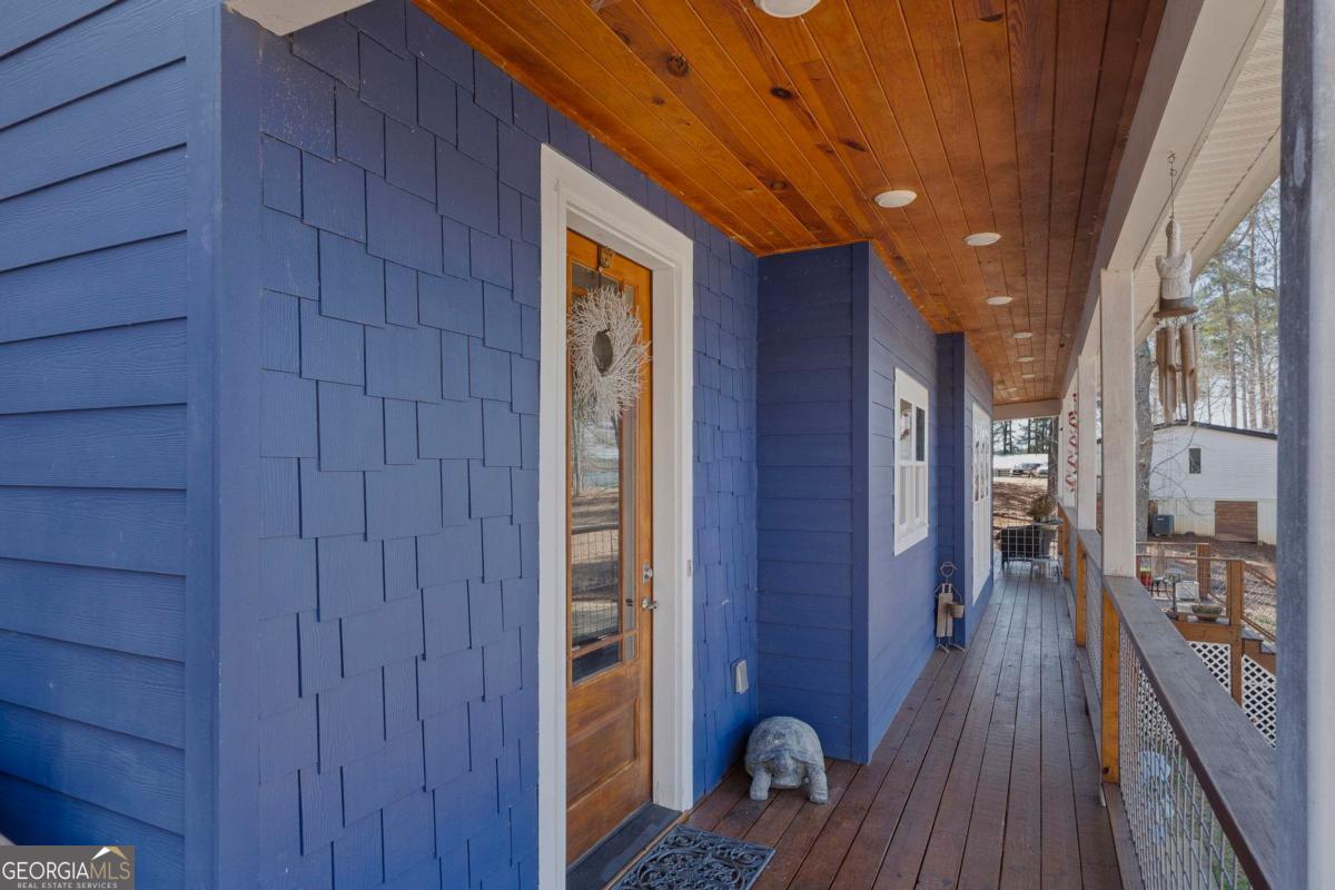 392 Big Oconee River Road Sparta, GA 31087 - Photo 8 of 69 a view of a hallway with wooden floor and staircase