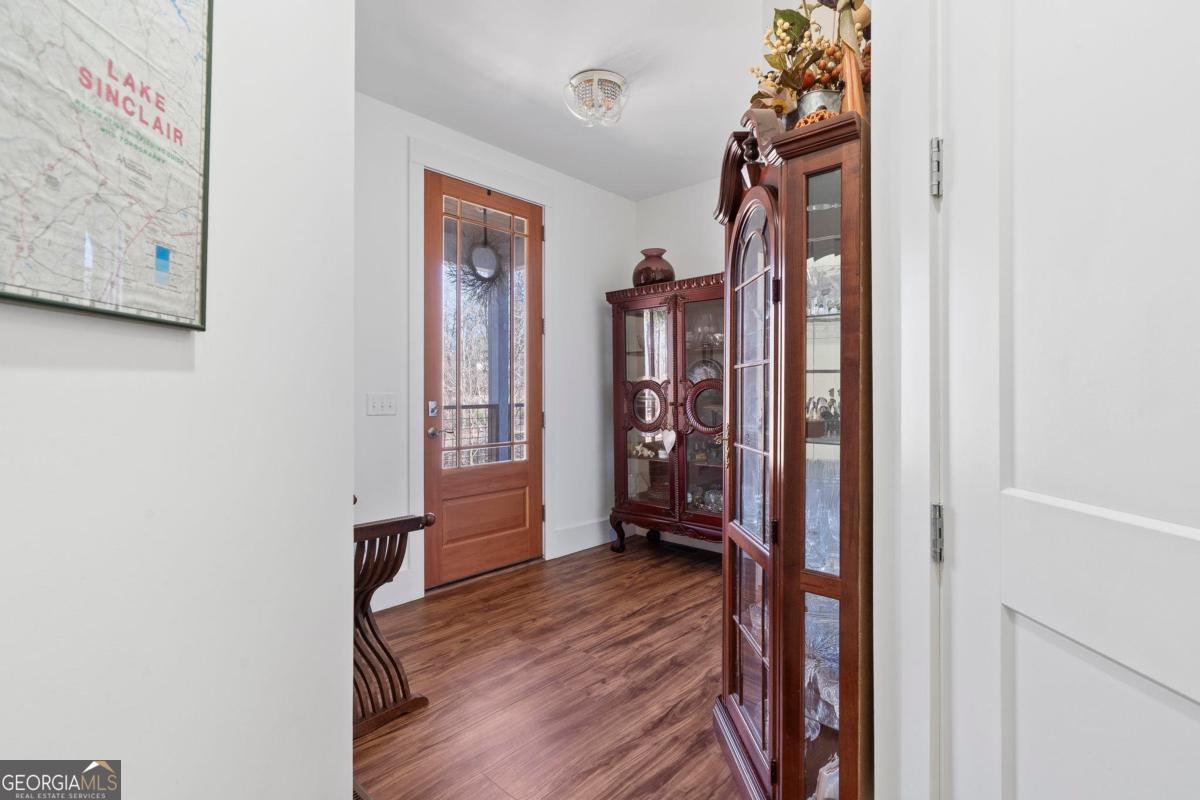 392 Big Oconee River Road Sparta, GA 31087 - Photo 10 of 69 a view of a hallway with wooden floor and closet