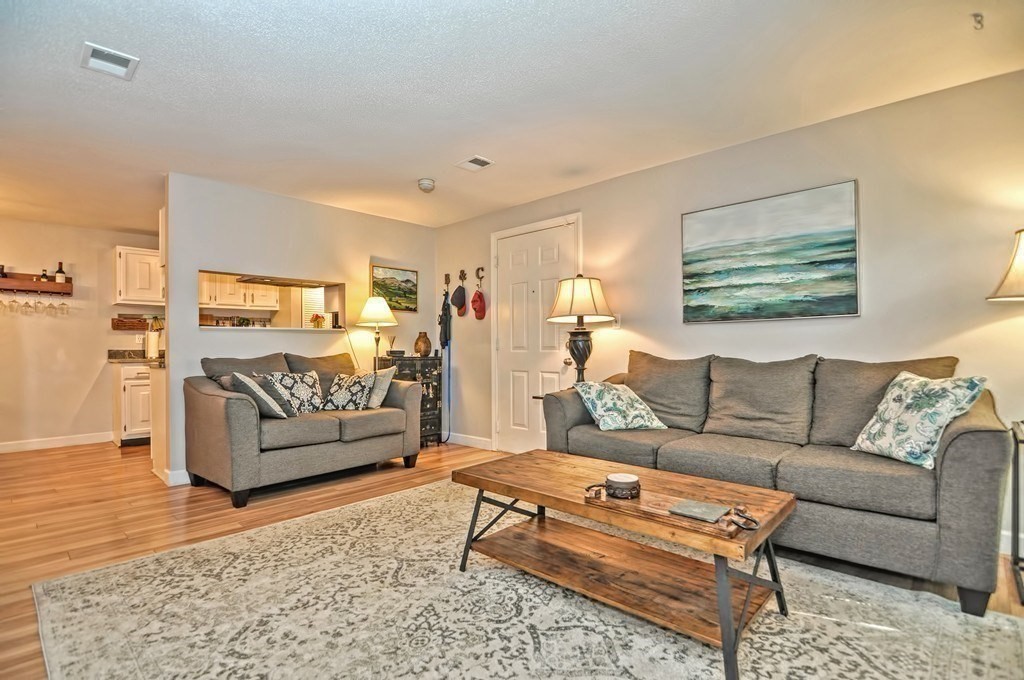 8 Walden Drive, Unit 13 Natick, MA 01760 - Photo 12 of 38 a living room with furniture and a rug