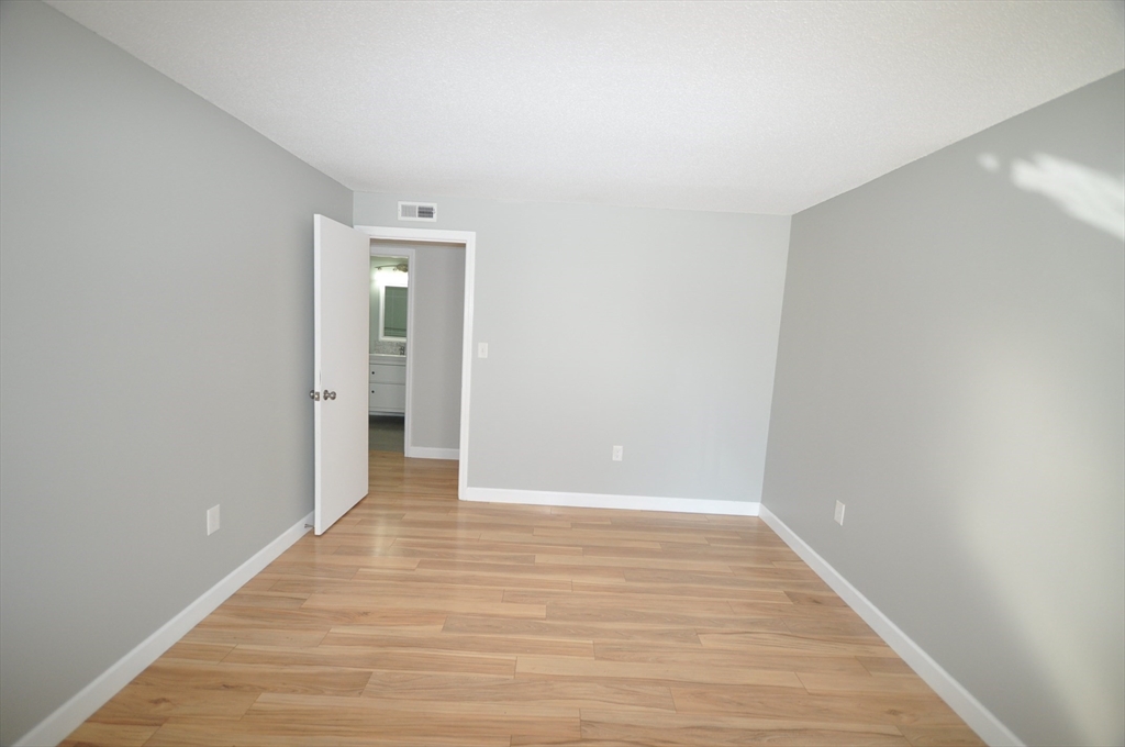 8 Walden Drive, Unit 13 Natick, MA 01760 - Photo 19 of 38 a view of an empty room with wooden floor