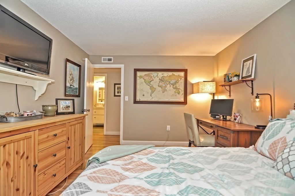 8 Walden Drive, Unit 13 Natick, MA 01760 - Photo 20 of 38 a bedroom with a bed and a flat screen tv