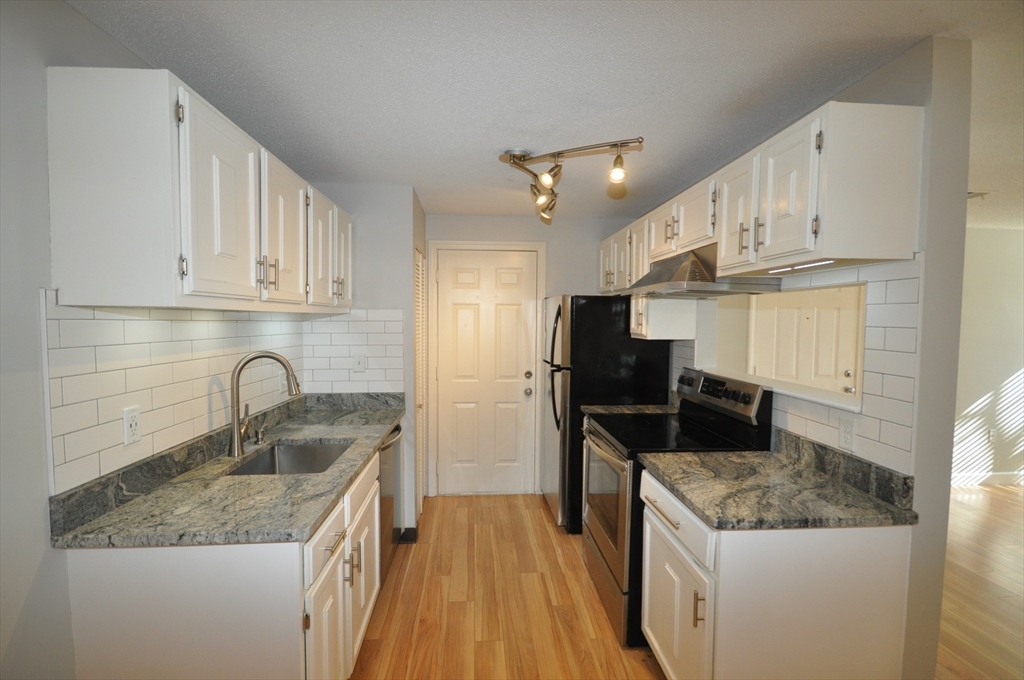 8 Walden Drive, Unit 13 Natick, MA 01760 - Photo 5 of 38 a kitchen with a sink stove and refrigerator