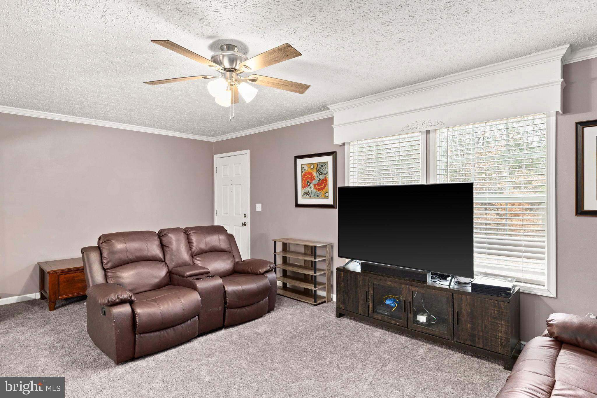 13115 Arcadia Road Woodford, VA 22580 - Photo 15 of 44 a living room with furniture and a flat screen tv