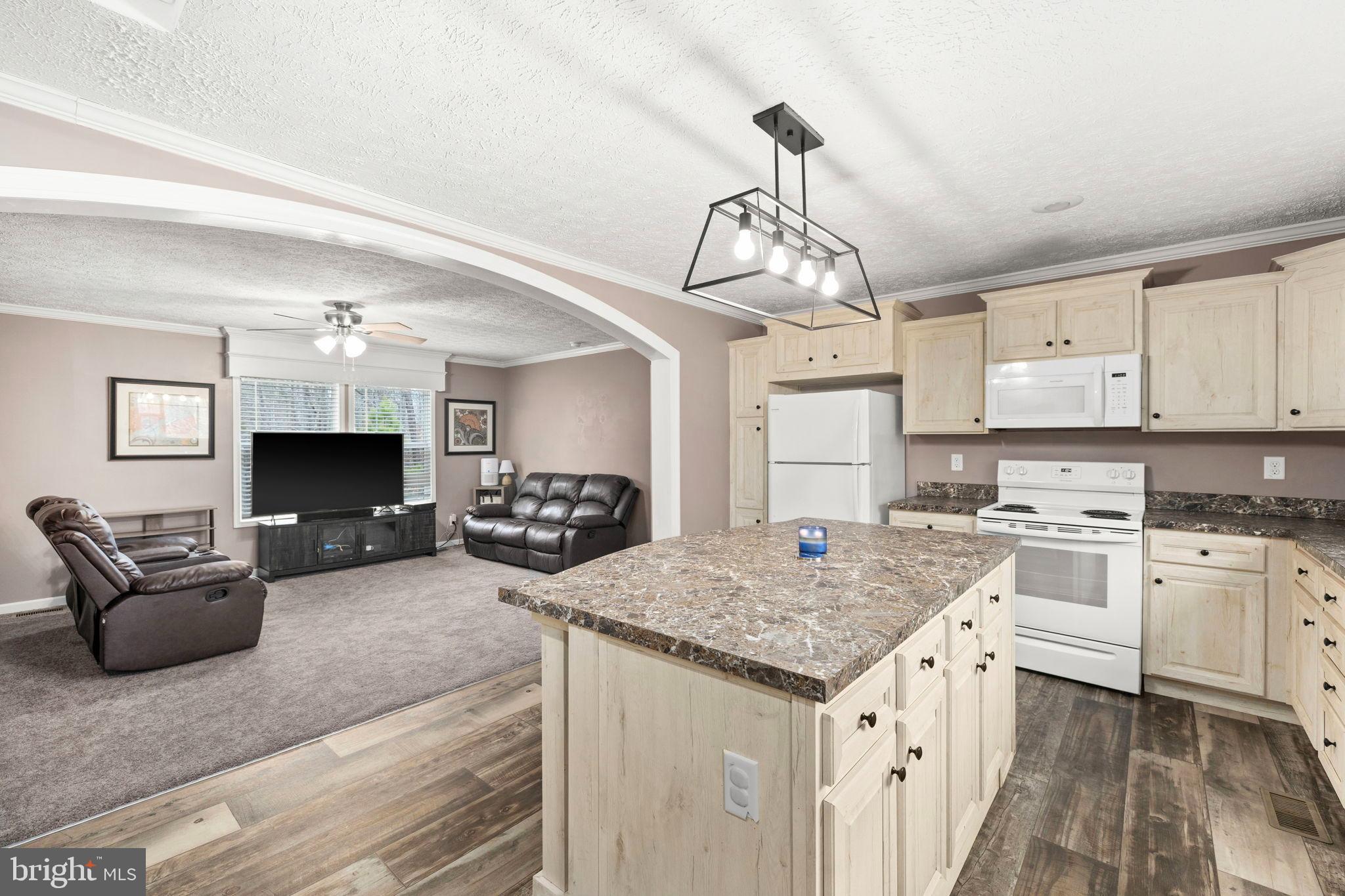 13115 Arcadia Road Woodford, VA 22580 - Photo 10 of 44 a view of living room kitchen and microwave