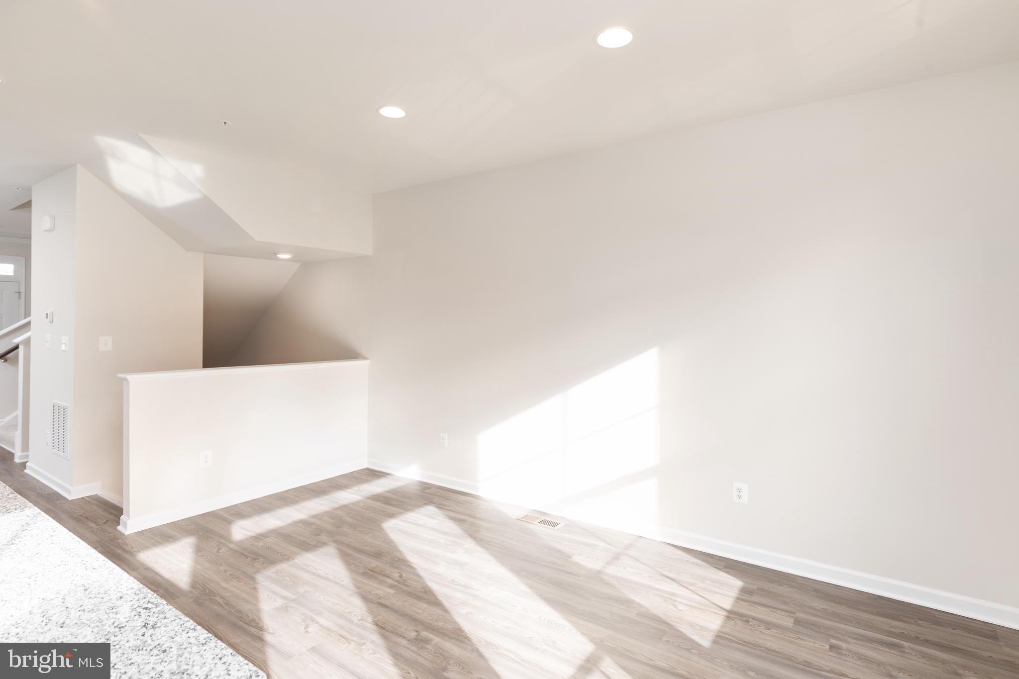 1815 Bird Run Frederick, MD 21702 - Photo 11 of 23 a view of a big room with wooden floor and a large window