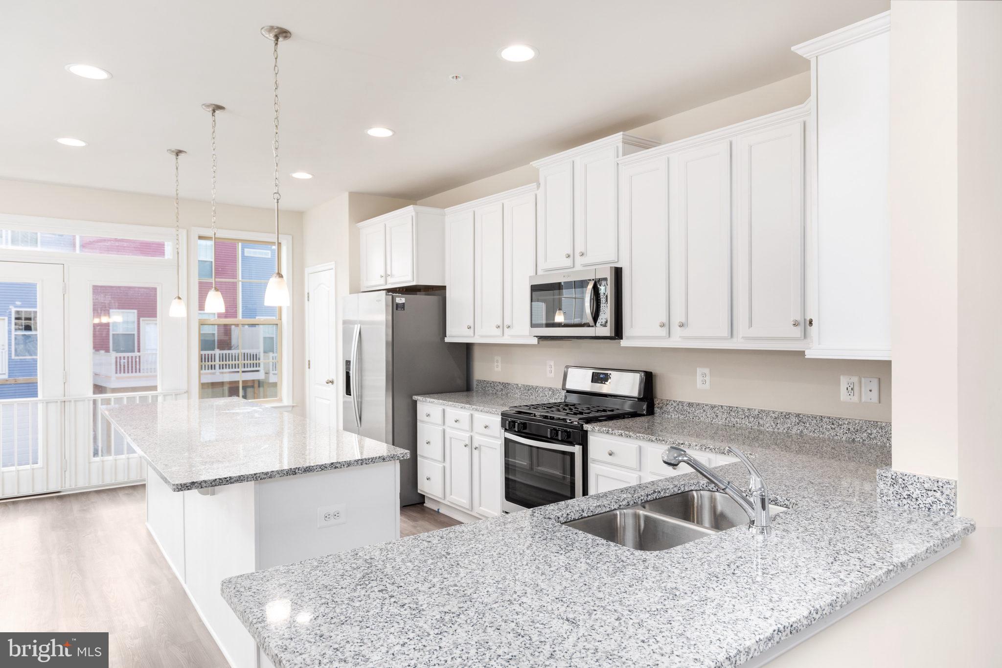 1815 Bird Run Frederick, MD 21702 - Photo 7 of 23 a kitchen with stainless steel appliances granite countertop a sink refrigerator and microwave