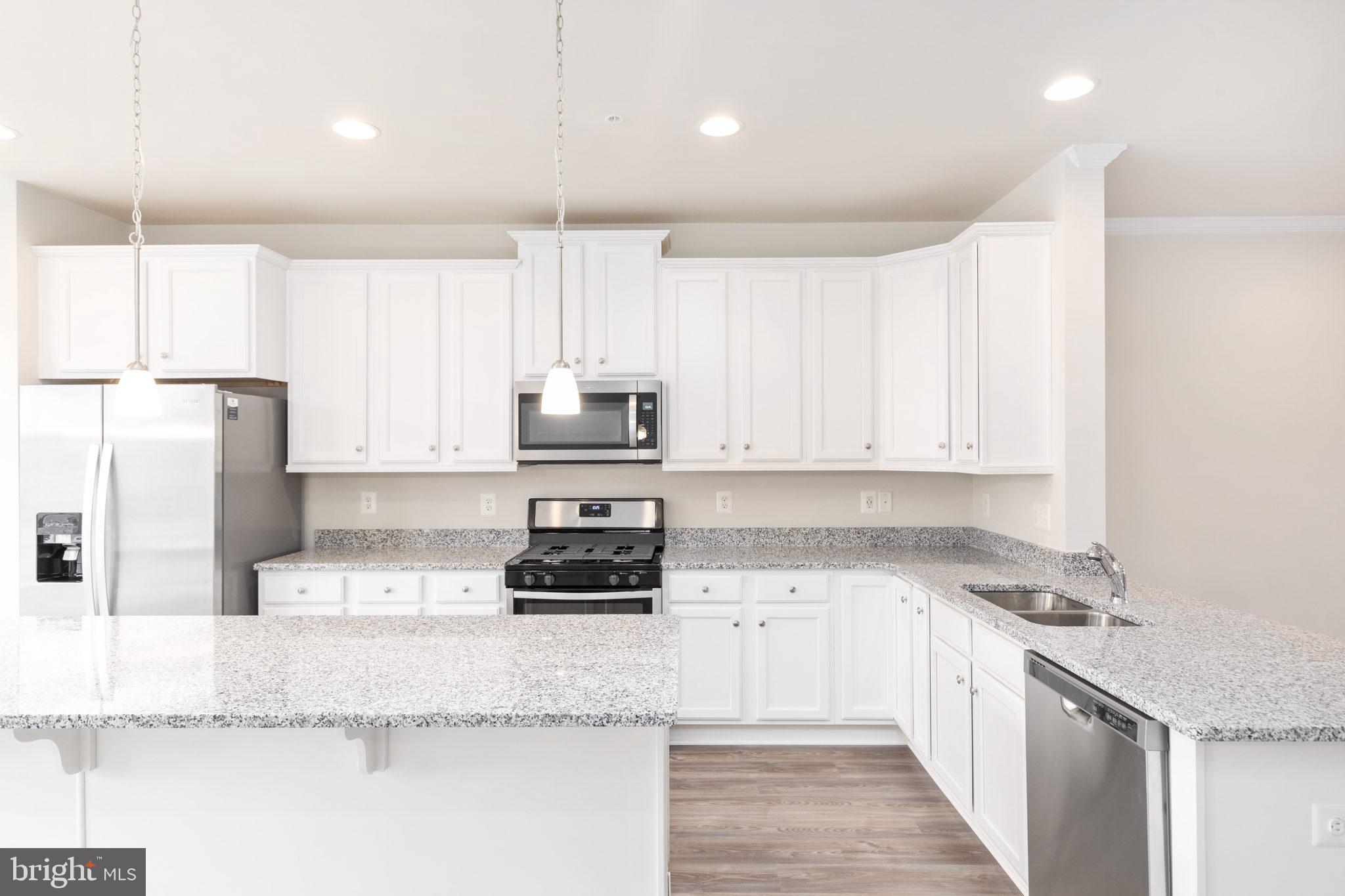 1815 Bird Run Frederick, MD 21702 - Photo 9 of 23 a kitchen with stainless steel appliances granite countertop a sink stove and refrigerator