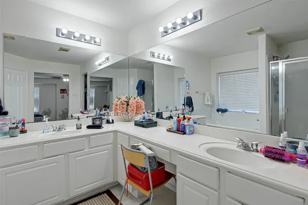 a bathroom with a sink double vanity and a mirror