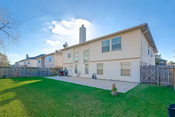a view of a house with a yard and sitting area