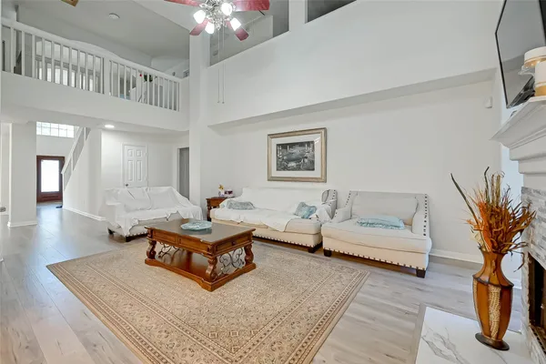 a living room with furniture and a chandelier