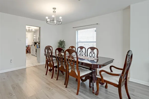 a view of a dining room with furniture and chandelier