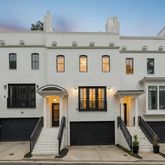 a front view of a house with large windows