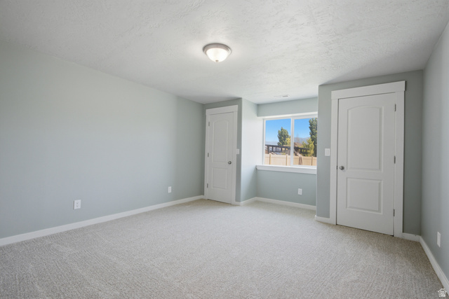 1252 Skyline Road Saratoga Springs, UT 84045 - Photo 36 of 51 Spacious room featuring light gray carpeting and cool-toned wall paint