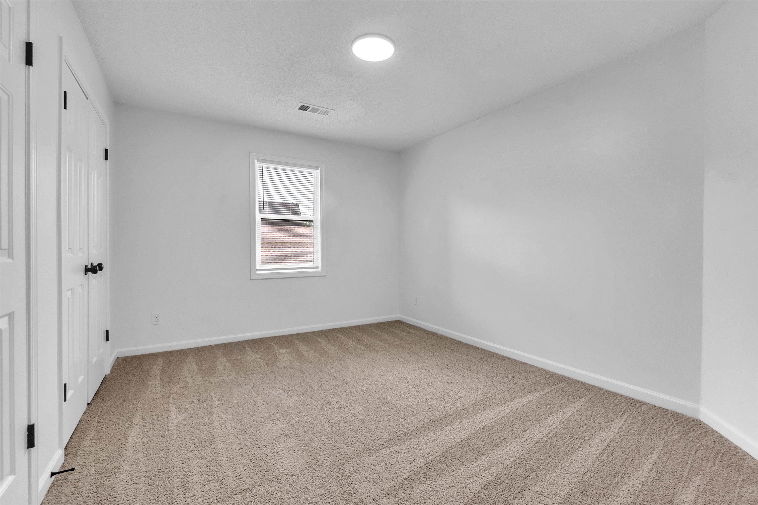 488 West Regis Place Memphis, TN 38018 - Photo 15 of 17 Unfurnished bedroom with light carpet and two closets