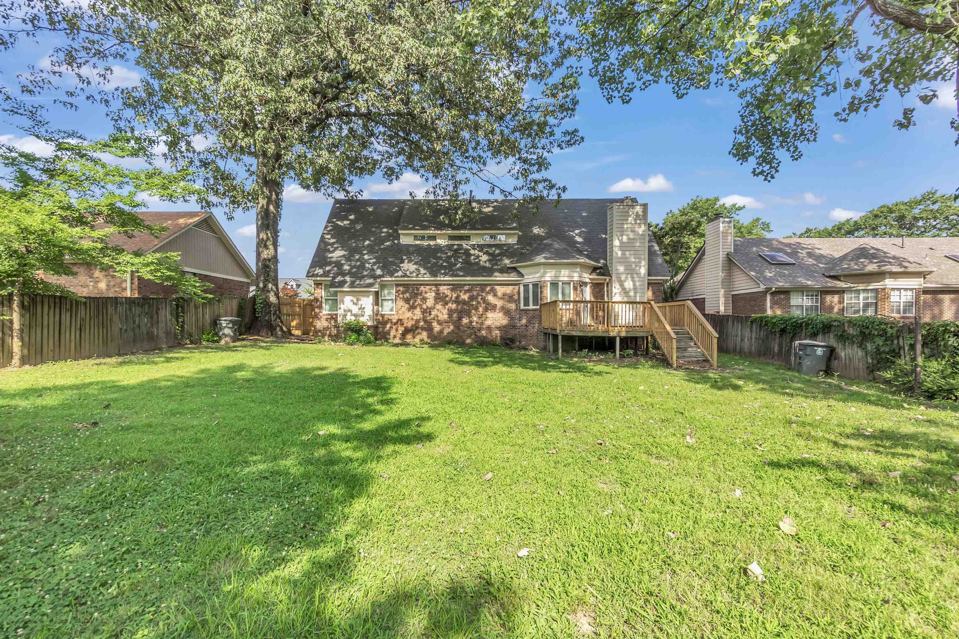 488 West Regis Place Memphis, TN 38018 - Photo 17 of 17 Rear view of property featuring a wooden deck, a fenced backyard, and brick siding